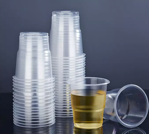 A thermoforming process where a heated plastic sheet is shaped over a mold, demonstrating the plastic forming into a detailed, three-dimensional shape